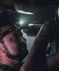Man wearing Enduro Pro 200 Lumen USB Rechargeable LED Headlamp With Elastic Head Strap while working in dim environment