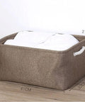 Hella Spacious Collapsible Storage Bins, Slick Foldable Canvas Fabric Cubes With Handles, Solid 3 Pack in natural color on wooden surface.