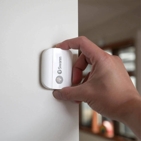 Person installing Wireless Motion Alert Sensor 2 Pack For Indoor And Outdoor Use Weatherproof And Easy Install No Hub Required.