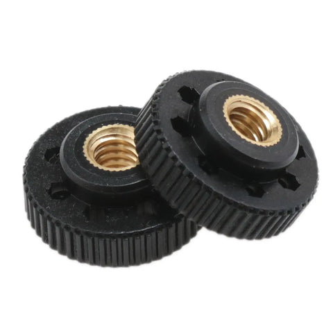 Close-up of Black 1/4-20 Inch Camera Nut Female Threaded Knurled Thumb Nuts Adapters with brass construction, 2 shown from a 4 pack.