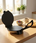 Leefasy Electric Pancake Maker With Nonstick Round Plate And Stainless Steel Construction on kitchen counter with pancakes and fruit.