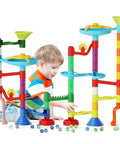 Child playing with Marble Run Toy Set With 110 Pieces And 60 Marbles STEM Educational Marble Maze Kit for Kids, colorful towers.