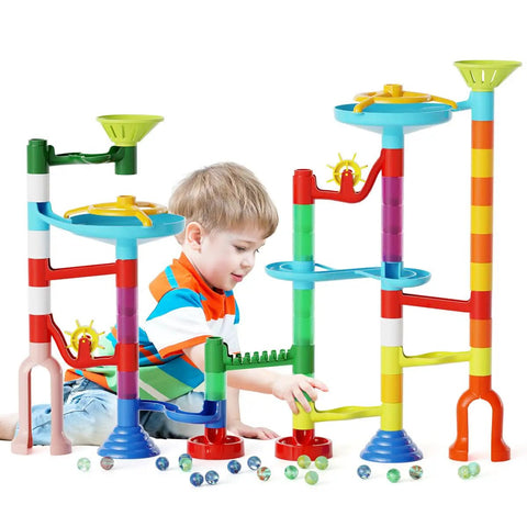 Child playing with Marble Run Toy Set With 110 Pieces And 60 Marbles STEM Educational Marble Maze Kit for Kids, colorful towers.