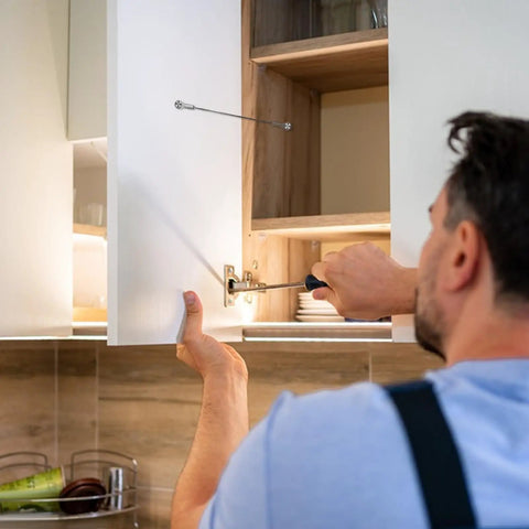 Man installing Premium Tough As Nails Stainless Steel Cabinet Door Stops And Hinge Limiters with adjustable size for kitchen cabinets.