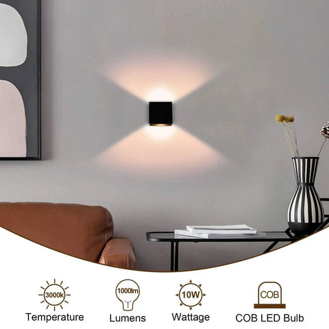 Dimmable 10W LED Indoor Wall Sconce in black finish on living room wall, up down light, warm 3000K glow, modern mini metal design.