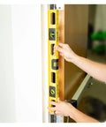 24 Inch Magnetic Top View Level Made In Usa Featuring Three Precision Vials For Dead On Accuracy held against a door frame.