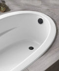 Tap To Open Close Bath Drain Trim Kit In Matte Black With Two Hole Overflow Faceplate installed in bathtub
