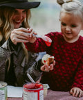 Parent and child enjoying campfire treat with red jelly, using Marshmallow Roasting Sticks Set Of 2 With Multiple Attachments.
