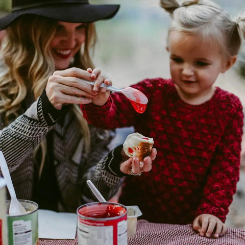 Parent and child enjoying campfire treat with red jelly, using Marshmallow Roasting Sticks Set Of 2 With Multiple Attachments.