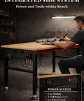 Man working at heavy duty 48 inch adjustable height workbench with power strip and pegboard in garage workshop.