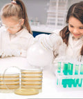Children using Science Kit For Kids With Ready To Use Bacteria Petri Dishes LB Agar And Cotton Swabs Safe STEM Project, smiling.