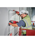 Top Shelf Brushless M18 Rotary Hammer With D Handle And Sds Plus Chuck drilling into concrete on a job site.