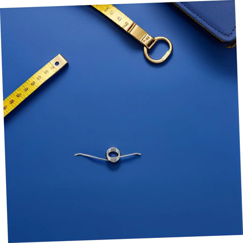 Top Shelf 20 Pack Metal Torsion Springs For Garbage Can Lids, Silent Operation Replacement Kit With Five Coils Perfect For Family Home Or Office Trash Cans That Work Like A Champ. silver five-coil torsion spring on blue background