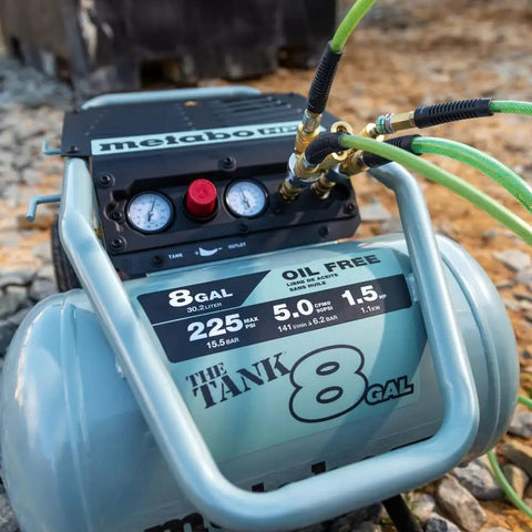 The Tank 8 Gallon Trolley Air Compressor With 225 PSI Built For Framing Siding Finish Or Roofing Nailers in use on rocky terrain