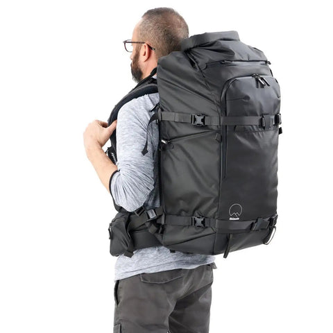 Man carrying Action X70 HD Backpack For Go To Outdoor Photography And Video Gear Heavy Duty Expedition Pack With Reinforced Load Support Roll Top
