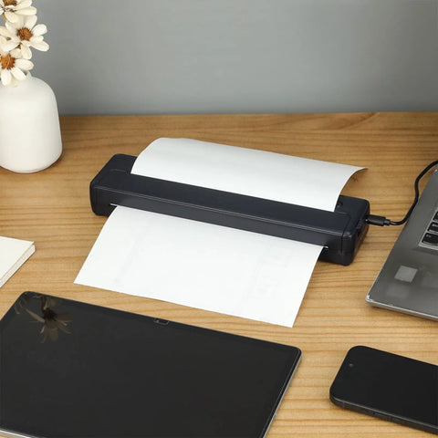 Slick Wireless Tattoo Transfer Stencil Printer For A4 Paper Offering Hassle Free Inkless Thermal Output on a desk with paper.