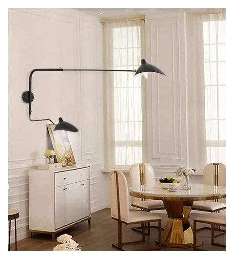 Slick Adjustable Double Head Wall Sconce Lamp In Modern Black Finish With Swivel Pole Design For Cozy Bedroom Reading Vibes And Chic Home Decor Upgrades located beside dining table.