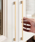 Hand reaching for installed 6 Pack 10 Inch Hole Centers Brushed Brass Cabinet Pulls Set For Cabinets And Drawers Zinc Alloy Gold Hardware