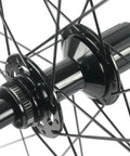 Close-up of 50mm Carbon Disc Brake Road Wheelset 700c Clincher 3K Matte Finish Lightweight hub with spokes.