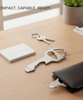 Metal Card Multitool With Bottle Opener, Flathead Screwdriver, and Hex Adjuster on desk, ultra slim and lightweight