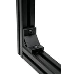 Eight Piece Set Of Tough As Nails Black Corner Brackets Built For 4040 And 4080 Aluminum Extrusion Profiles Featuring Slick Anodized Finish And Complete M8 Hardware Bundle, close-up of black bracket at corner of aluminum frame.