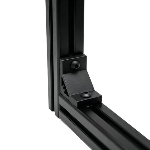 Eight Piece Set Of Tough As Nails Black Corner Brackets Built For 4040 And 4080 Aluminum Extrusion Profiles Featuring Slick Anodized Finish And Complete M8 Hardware Bundle, close-up of black bracket at corner of aluminum frame.