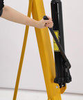 Close-up of a person operating a hydraulic pump on a 2 Ton Cherry Picker Engine Hoist With Folding Hydraulic Crane And Six Swivel Castors Designed For Easy Engine Removal In Auto Repair Shops Garages And Workshops Pro Grade Build Durably Built And Ready For Heavy Duty Use Yellow