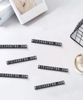 Price Display Cube Tags Set 50 With Adjustable Stand for jewelry shop, showing black plastic dollar block cubes on white background.