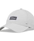 Titleist golf hat in light grey with perforated back panel, curved brim, and logo patch on front. Featuring starburst perforations and adjustable backstrap.