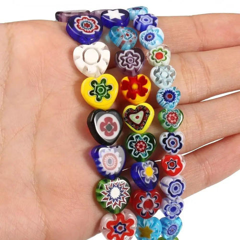 Premium Quality Fresh Hella Sparkly Lampwork Glass Beads Loose Round Spacers For Diy Bracelet Necklace Jewelry Crafting And Dress Decor Accents 10Mm 44 Pieces, heart-shaped colorful beads in hand.