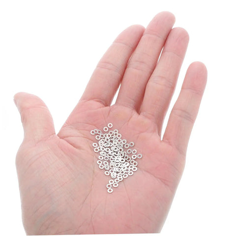 Metal Eyeglass Screw Washers Set, 200 Pcs Rimless Glasses Gaskets and Frame Tighteners in hand, silver washers for eyewear repairs.