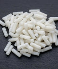 Top Shelf M4 X 12mm Nylon Slotted Set Screws, white plastic grub fasteners scattered on dark surface