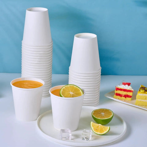 300 Pack Disposable Coffee Cups, 10 Oz White Hot Beverage Cups on table with drinks and desserts, sturdy leak proof rolled rim paper cups, thick walls and poly lining