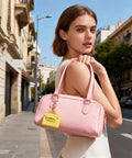 Snag These Hella Adorable Mini Backpack Keychains For Bags And Keys PU Leather Coin Purse Makeup Pouch Cable Organizer Compact Accessory Bundle Ideal For Women Seeking Functional Fashion Vibes Daily in pink handbag held outdoors.