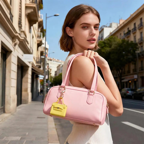 Snag These Hella Adorable Mini Backpack Keychains For Bags And Keys PU Leather Coin Purse Makeup Pouch Cable Organizer Compact Accessory Bundle Ideal For Women Seeking Functional Fashion Vibes Daily in pink handbag held outdoors.