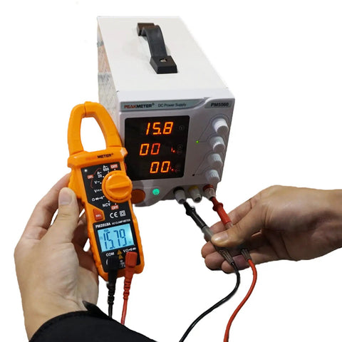 Person using Auto Ranging Clamp Meter For Electricians, Measures AC Current Up To 600A And AC And DC Voltage Up To 600V on power supply.