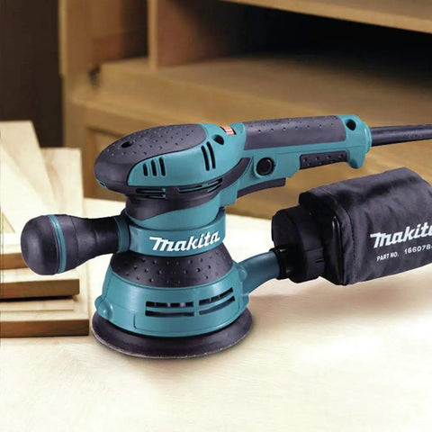 5 Inch Random Orbit Sander With 3 Amp Motor And Variable Speed Dial 4,000 To 12,000 OPM on workshop table
