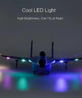 RC Airplane Toy with Lights, Su-35 Style Glider, illuminated with vibrant LED lights, nighttime view.