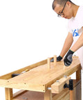 Person working on 55 Inch Heavy Duty Rubber Wood Workbench With 3 Drawers Storage Cabinet Tool Well And Adjustable Vise Pro Grade