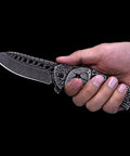 Pocket Folding Knife With 3D Skull Embossed Handle And Razor Sharp 440 Stainless Steel Blade shown in hand