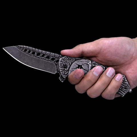 Pocket Folding Knife With 3D Skull Embossed Handle And Razor Sharp 440 Stainless Steel Blade shown in hand