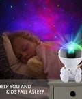 Child sleeping under Mini Galaxy Projector Night Light With Remote Control for Kids Bedroom Ceiling Decor Nebula Aurora Starry Sky Projector, Lit For Cars, Offices, And Game Rooms, Cute Astronaut Version 2 casting nebula.