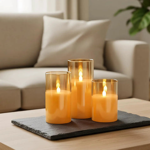 Gold Glass Flameless LED Candles Set Of 3 With 10Key Remote And Timer Real Wax Finish Warm White Flicker on a coffee table
