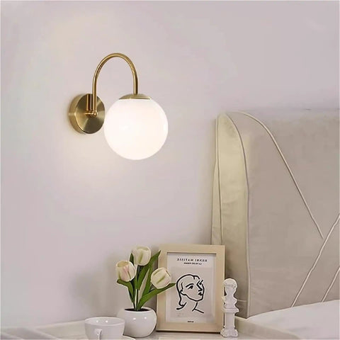 Gold Wall Sconce Mid Century Modern Wall Mount Light Hardwired Sconces Wall Light with Milky White Glass Shade Indoor Bedside Wall Lamps for Living Room Hallway above a bedside table.