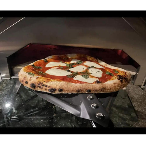 9 Inch Round Perforated Aluminum Pizza Peel With Detachable 40 Inch Handle Lightweight Yet Durable Pizza Turner For High Heat Ovens Outdoor Pizza Oven Accessories For Easy Slide And Turn Pro Grade - pizza being turned