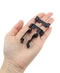 Hand holding Durable 35mm DIN Rail End Cap Protector Covers For Terminal Blocks, Black Plastic End Mount, Clamp Style, 30 pack.
