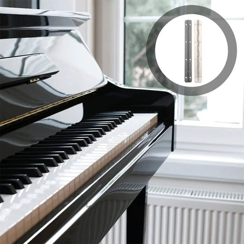 Six Piece Heavy Duty Piano Hinges Forged From Solid Iron For Tough Jewelry Boxes And Travel Luggage Rugged Construction Keeps Things Locked Tight During A 180 Degree Open displayed next to a grand piano.