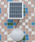 JUDYSSY Led Solar Flood Light,Two-Color Remote Ligent timing solar panel and round lamp mounted on tiled wall.