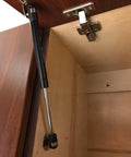 4 Pack 10 Inch Cabinet Gas Struts 100N Lift Supports for Cabinets Kit installed, showing soft close mechanism on a wooden cabinet door
