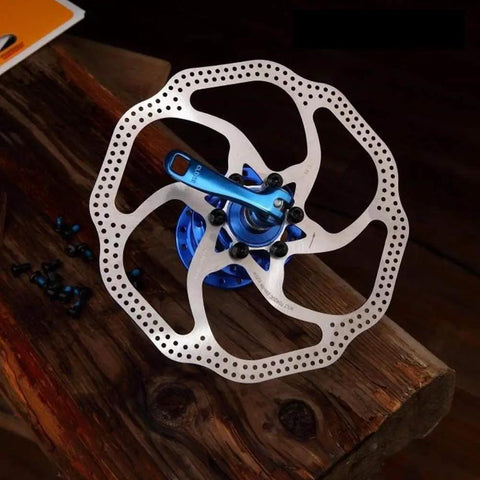 180mm 6 Bolt Stainless Steel Disc Brake Rotor for Road, Mountain, MTB and BMX Bikes on wooden table
